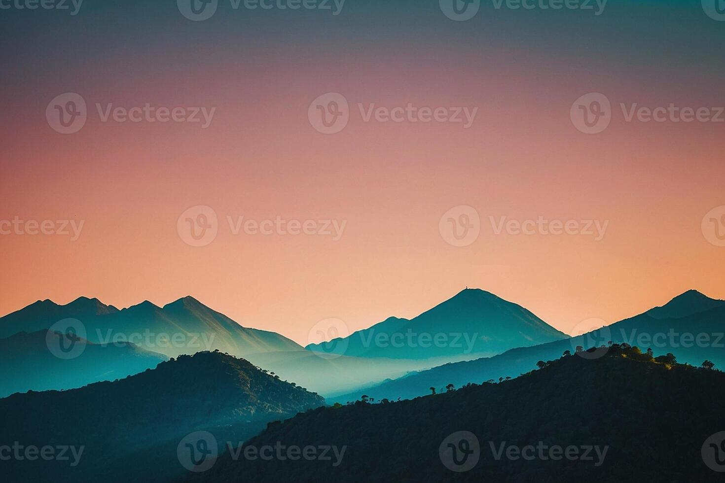 a mountain range with a sunset in the background photo