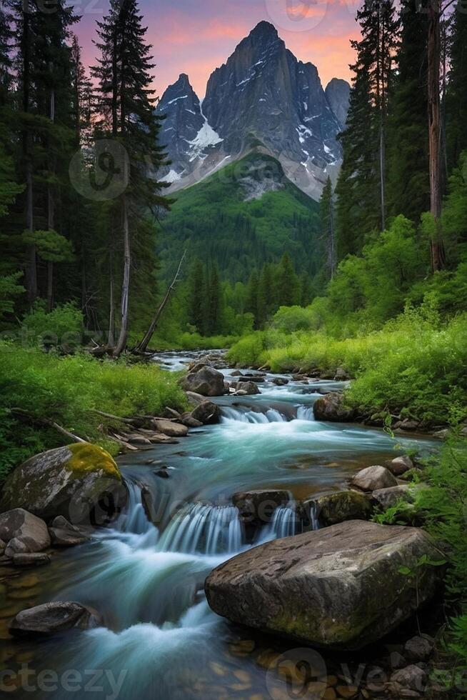 a river flows through a forest with mountains in the background photo