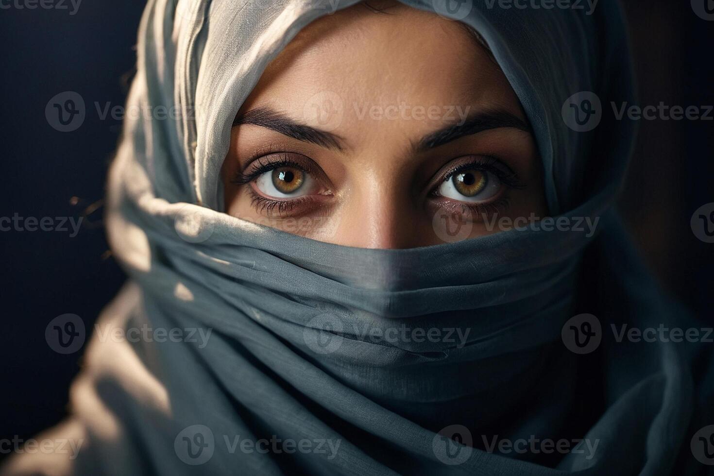 a woman wearing a headscarf and looking into the camera photo