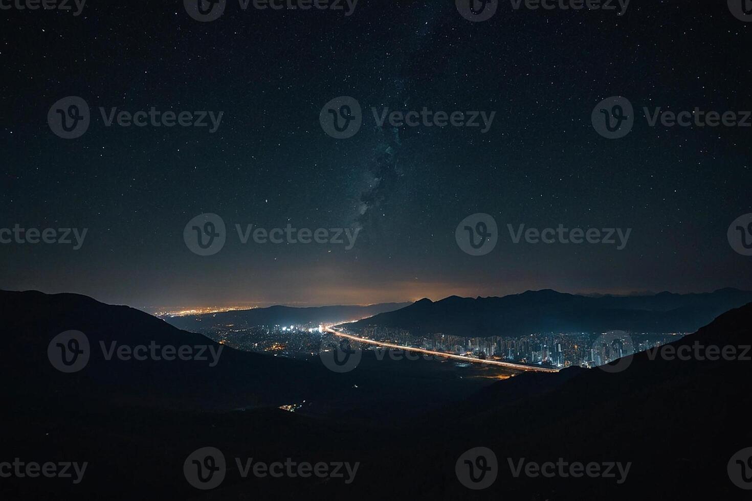 the night sky over a city and mountains photo