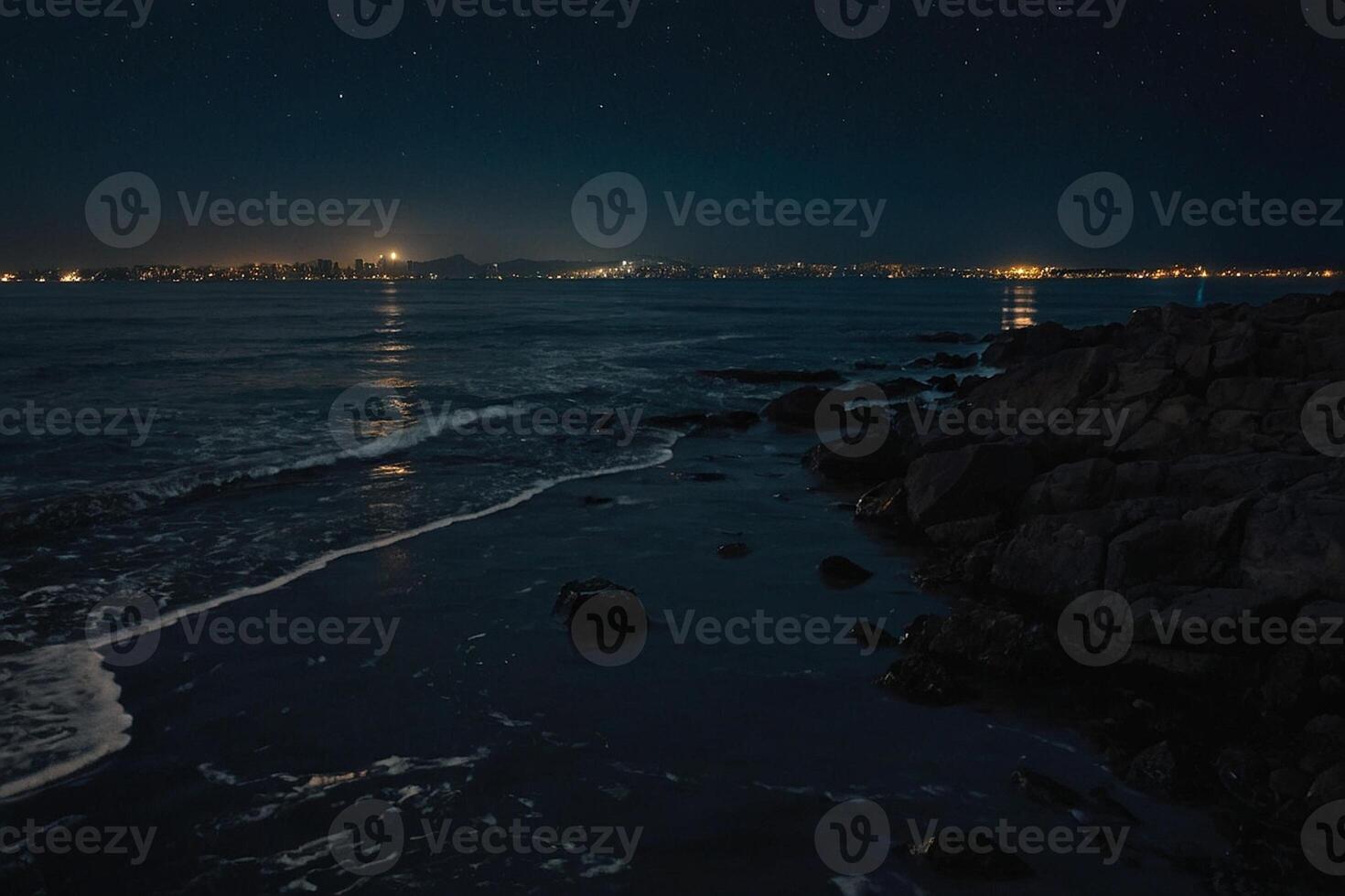 the night sky over a city and mountains photo