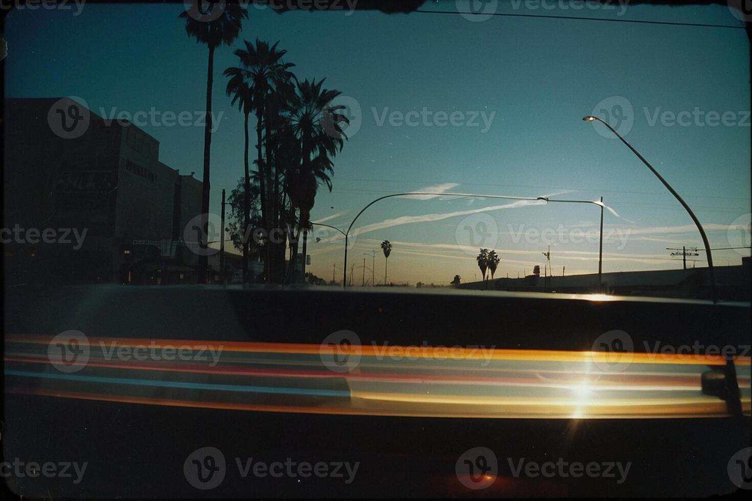 the sun is setting behind a street sign photo