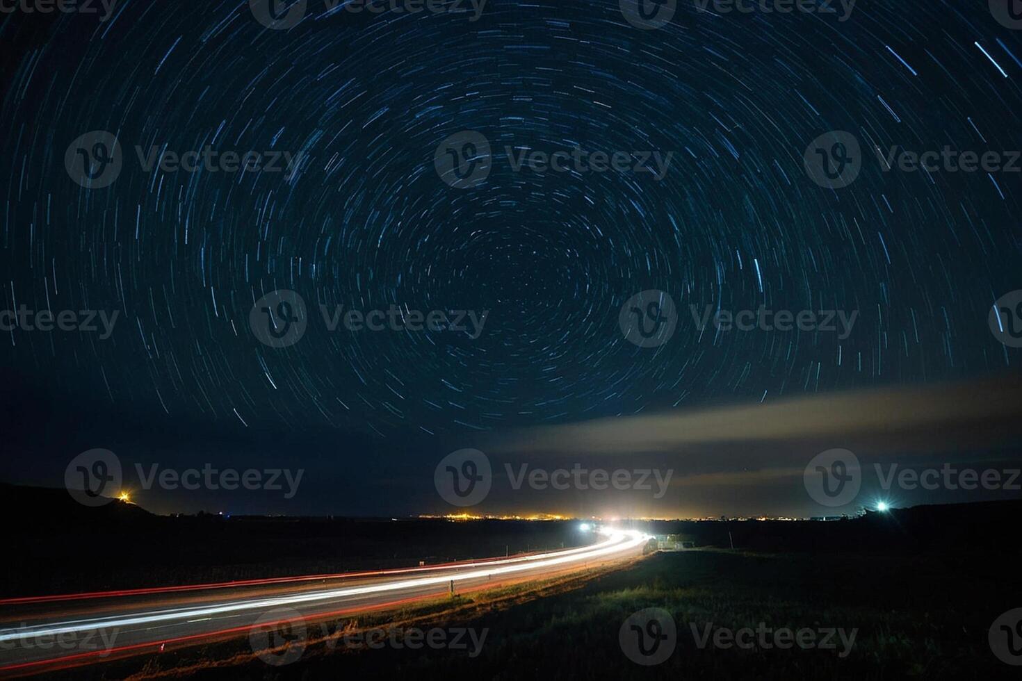 star trails over a highway at night photo