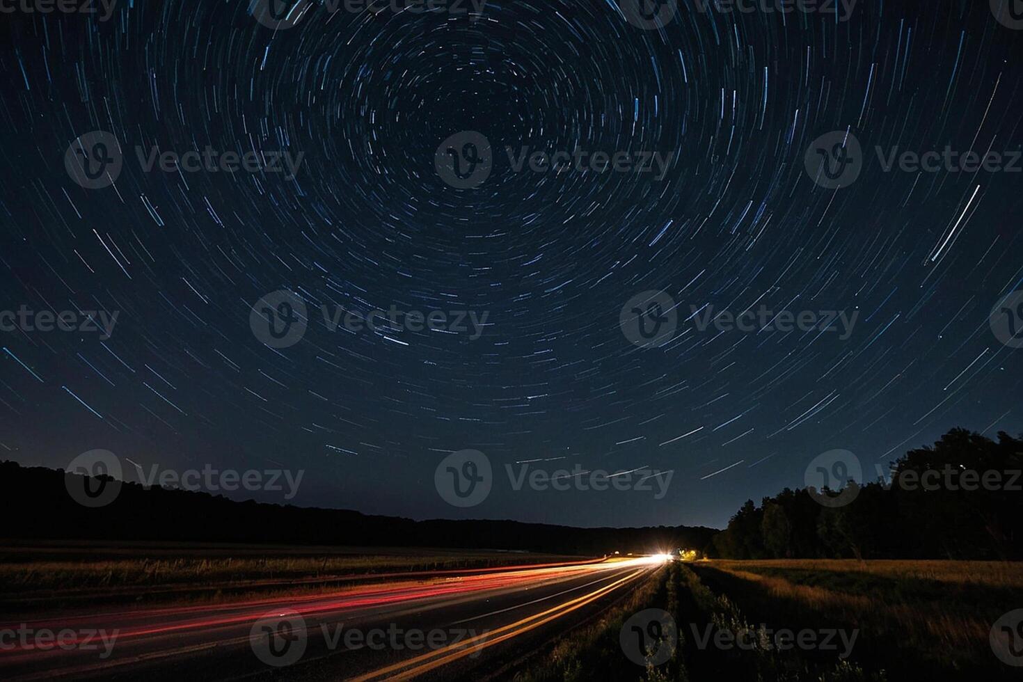 star trails over a highway at night photo