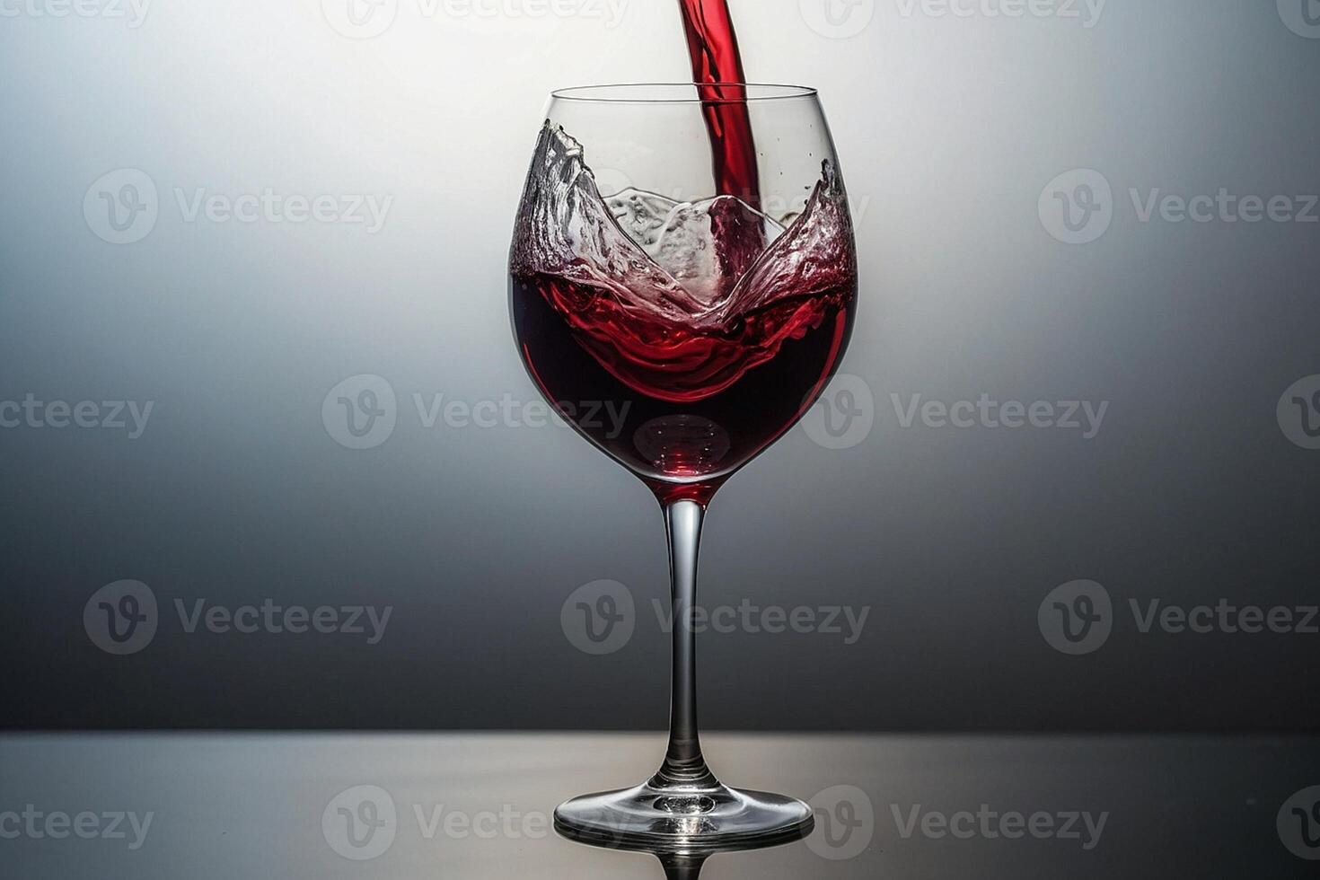 red wine pouring into a glass photo