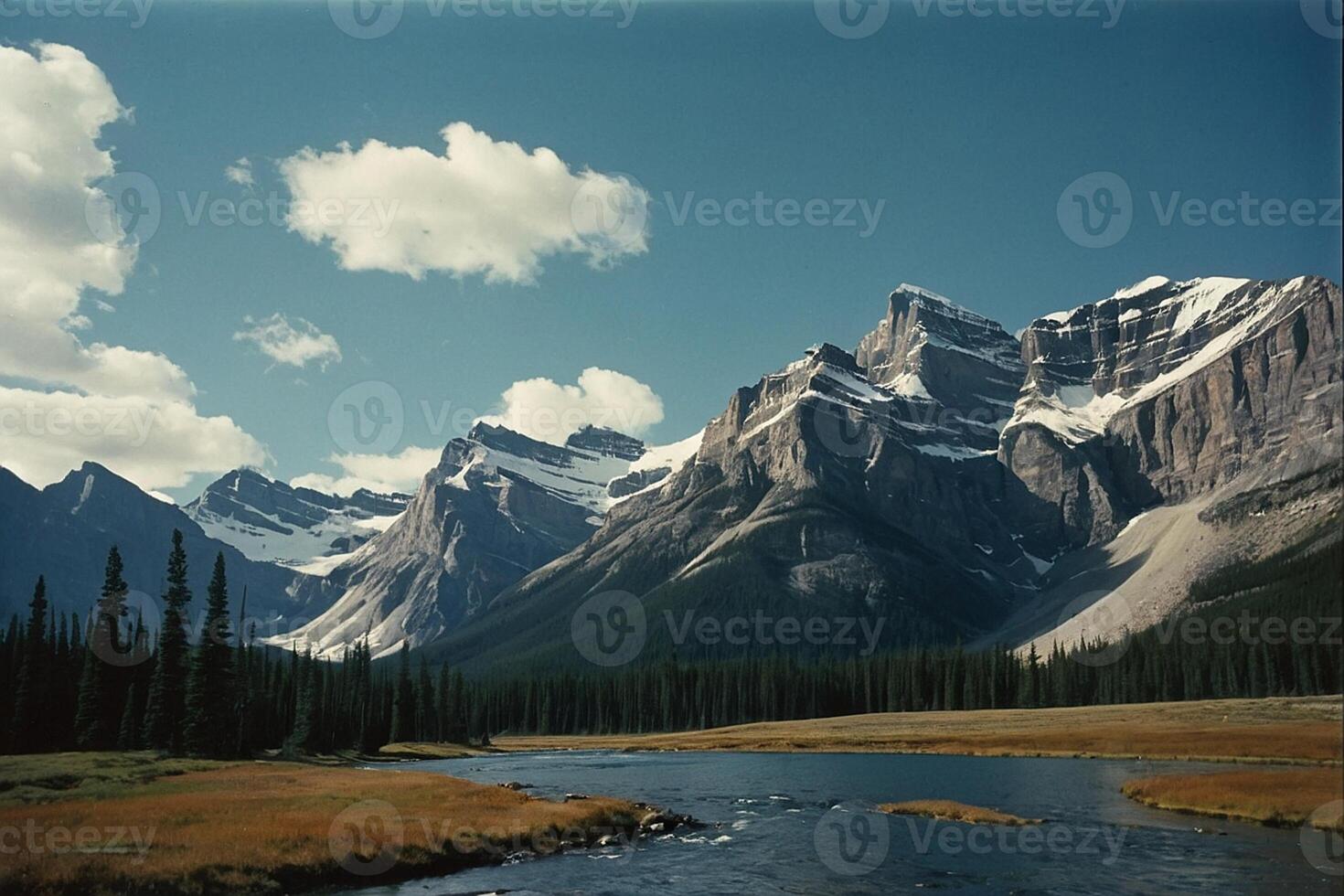 a river runs through a valley surrounded by mountains photo