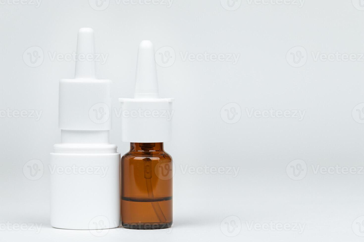 Two spray bottles of medicine on light background photo