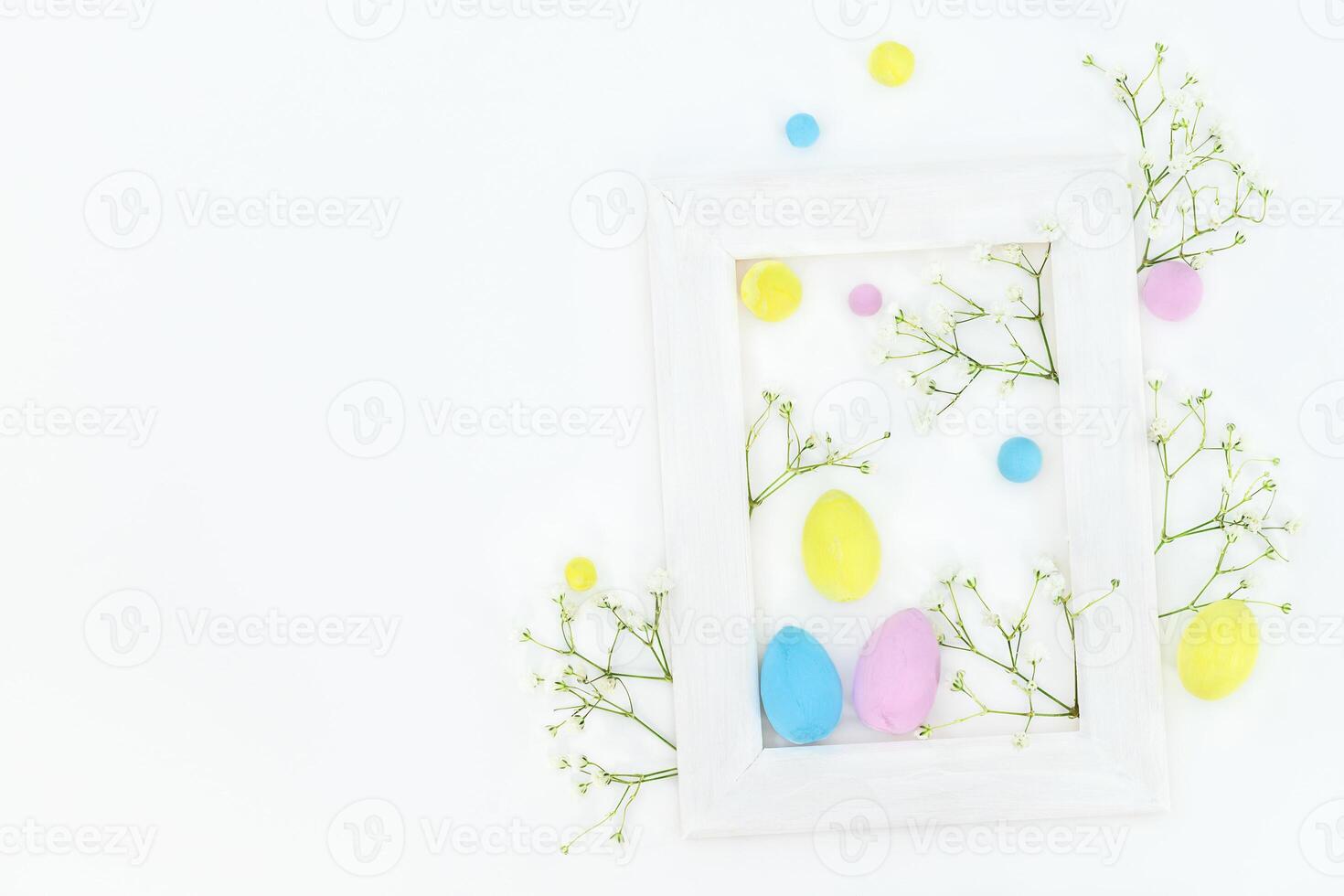 Easter spring composition with color eggs, flowres and frame photo