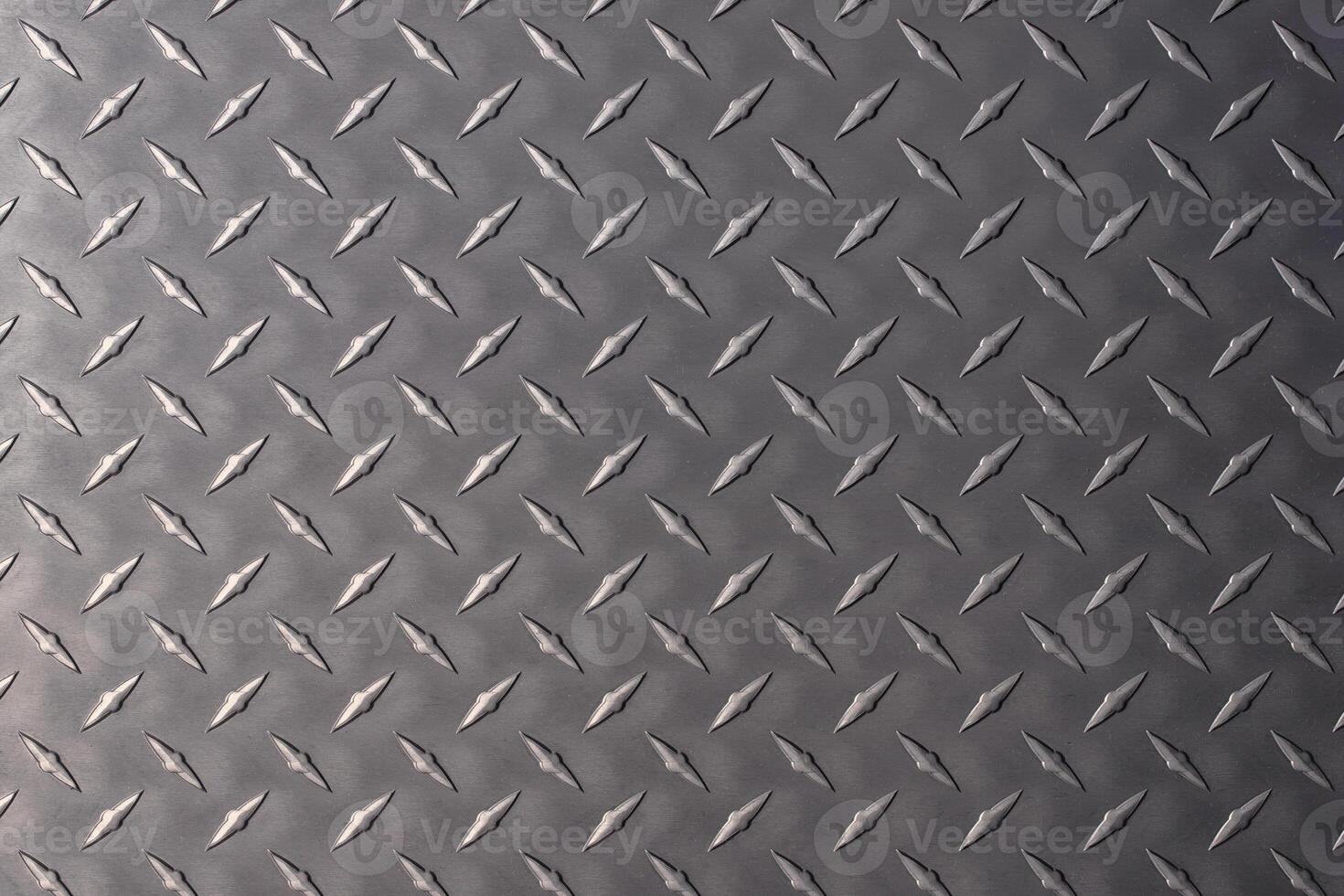 dark metal plate as background. steel texture with a rhombus pattern. photo