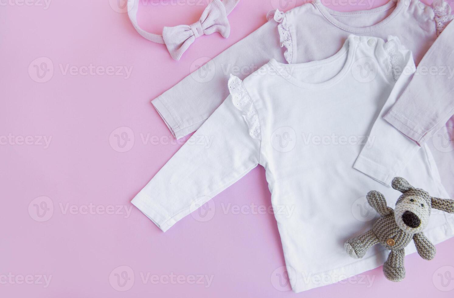 Set of baby bodysuits, pants, socks and knitted toy photo