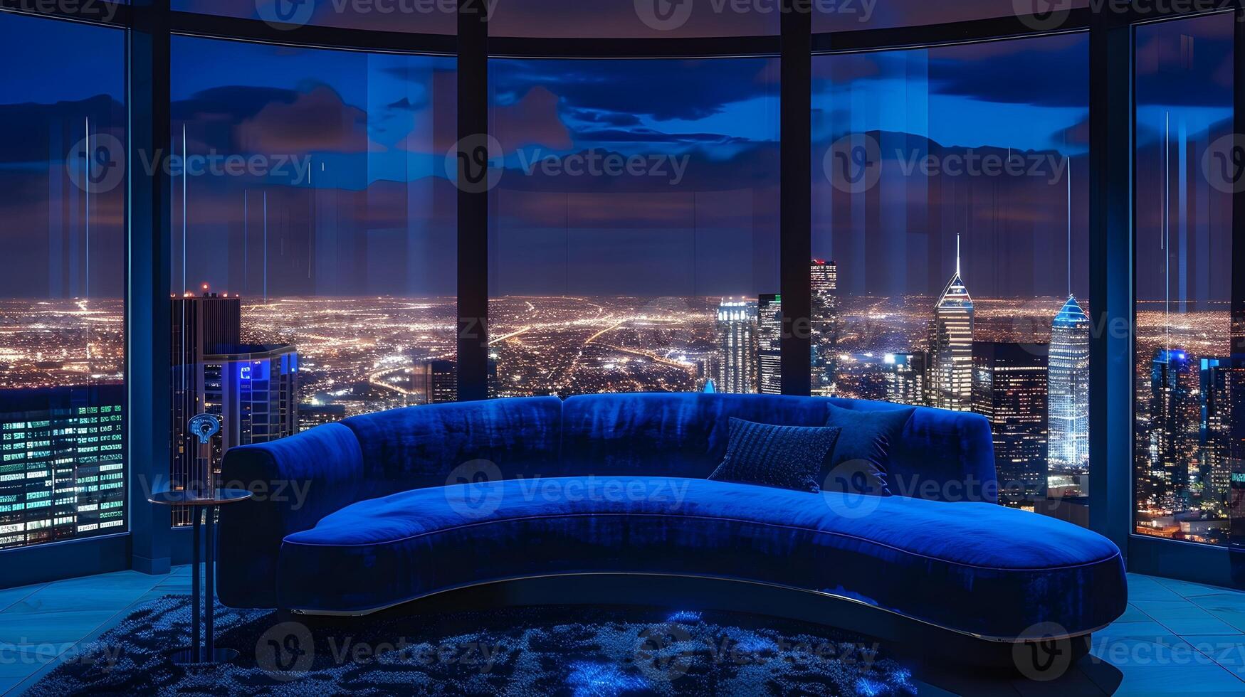 Magnificent Nighttime Cityscape Framed by Lavish Curved Sofa in Luxury Penthouse photo