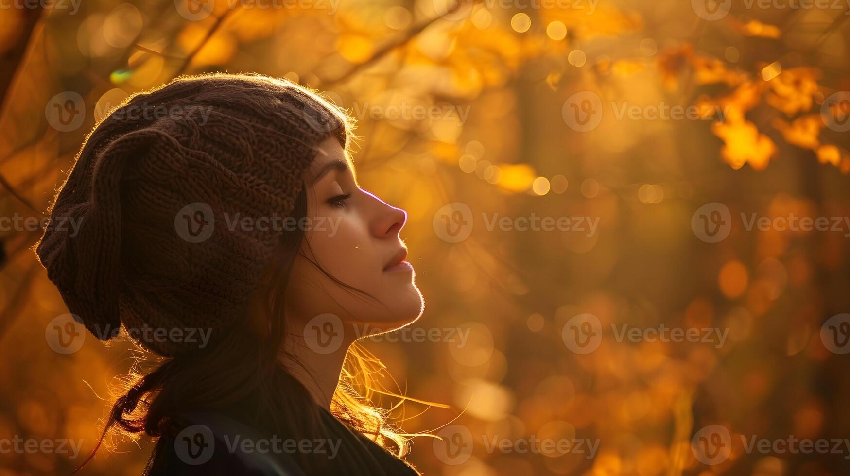 Autumns Embrace Peaceful Woman in Cozy Knit Cap Absorbed by Golden Forest Foliage photo