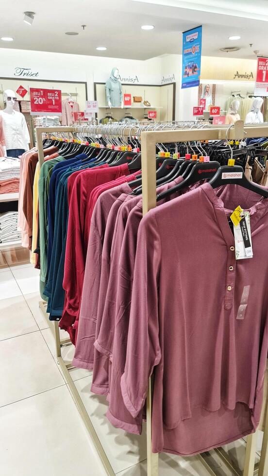 Bekasi, Indonesia on December 20, 2023. Rows of hangers with the words several women's clothes hanging on them. photo
