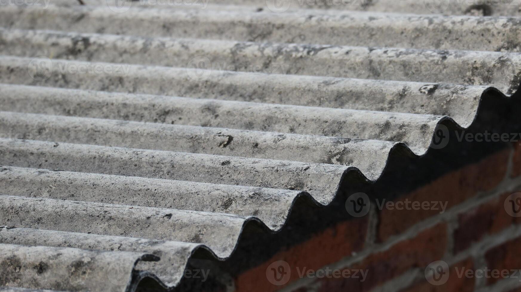 Asbestos roof tiles that have started to become ugly, originally gray in color are starting to show black spots. photo