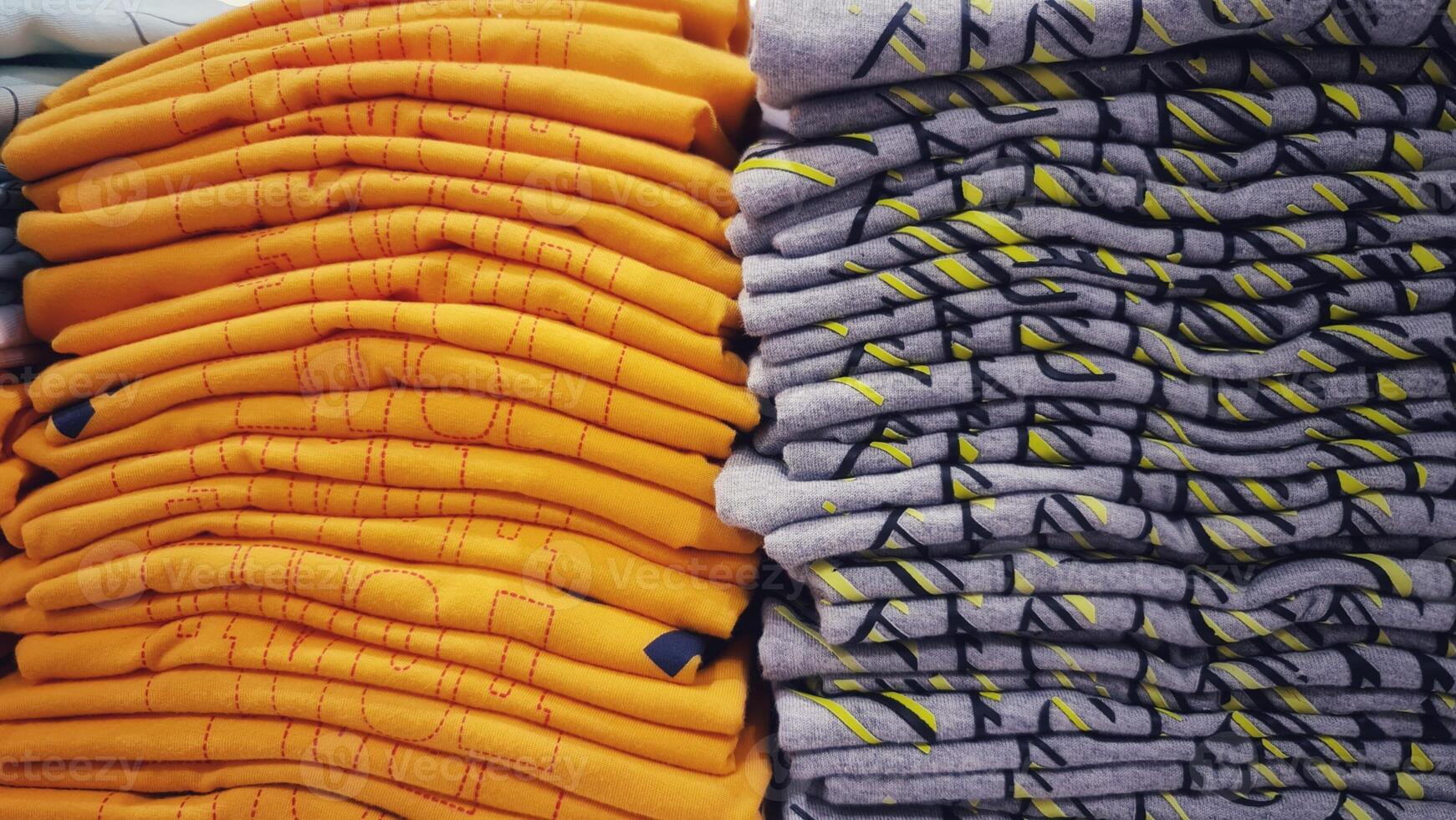 A pile of children's clothes in a clothing store. Discount cotton clothing. photo