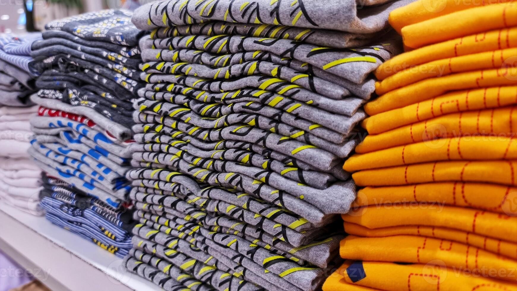 A pile of children's clothes in a clothing store. Discount cotton clothing. photo