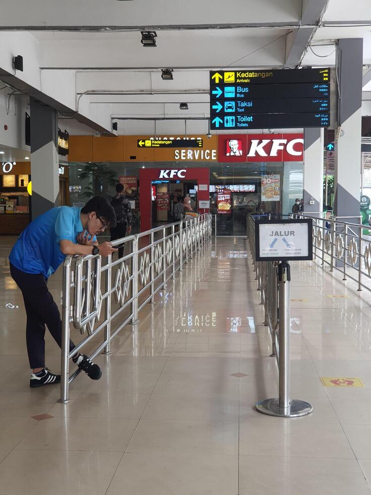 Jakarta, Indonesia on July 7 2022. The atmosphere from the exit of the Arrival section of Halim Perdanakusuma Airport, you can see passengers entering and officers standing guard. photo