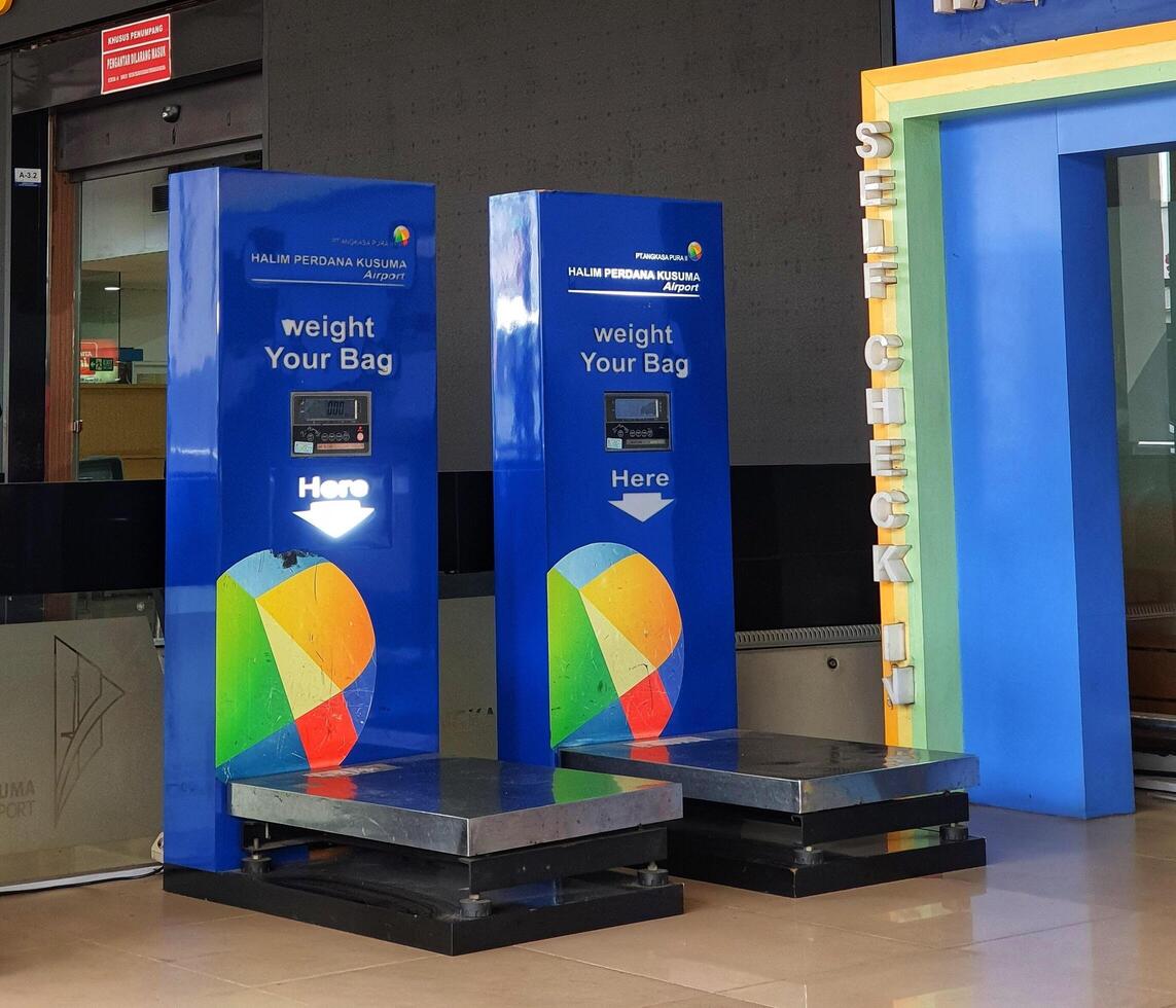 Jakarta, Indonesia on July 7 2022. The atmosphere from the departure entrance of Halim Perdanakusuma Airport, visible to passengers entering and officers on guard. There is also a self check for the photo