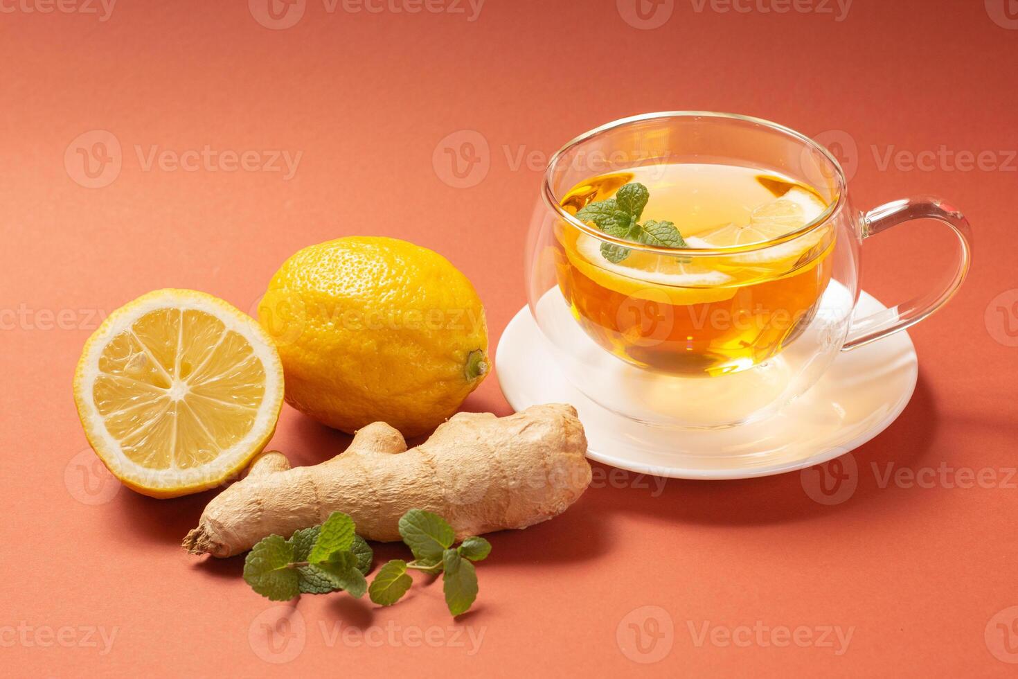 Ginger tea with mint and lemon. Healthy drink. Crystal cup on bright background. Selective focus. photo