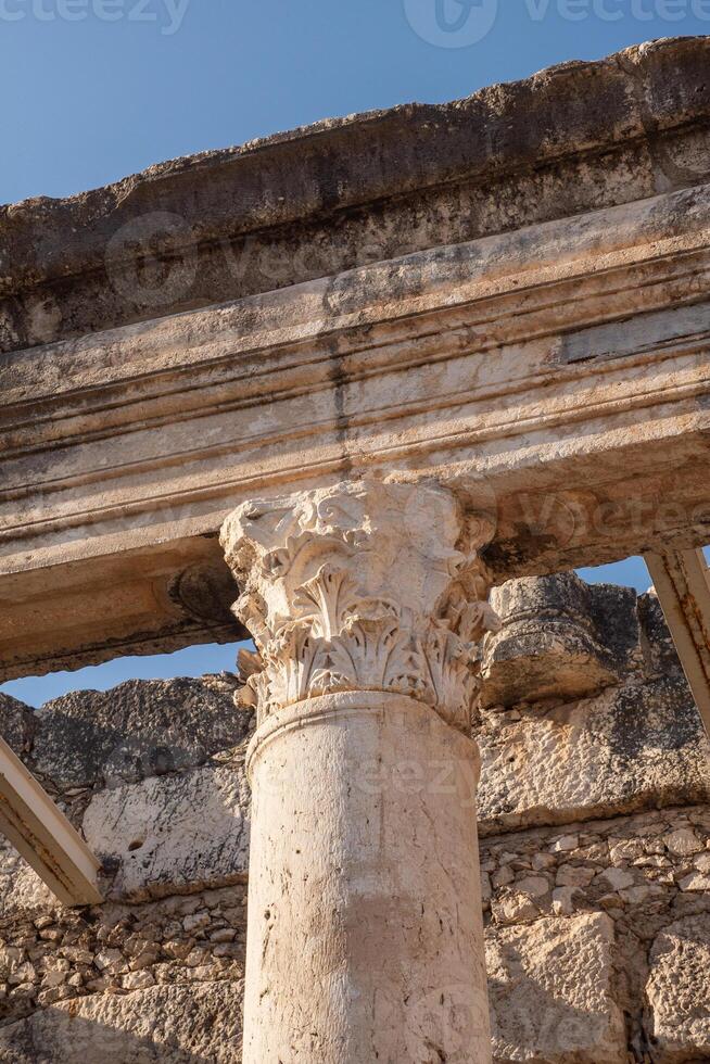 Antique column in the ruins of an ancient city in Israel. Building architecture element. photo