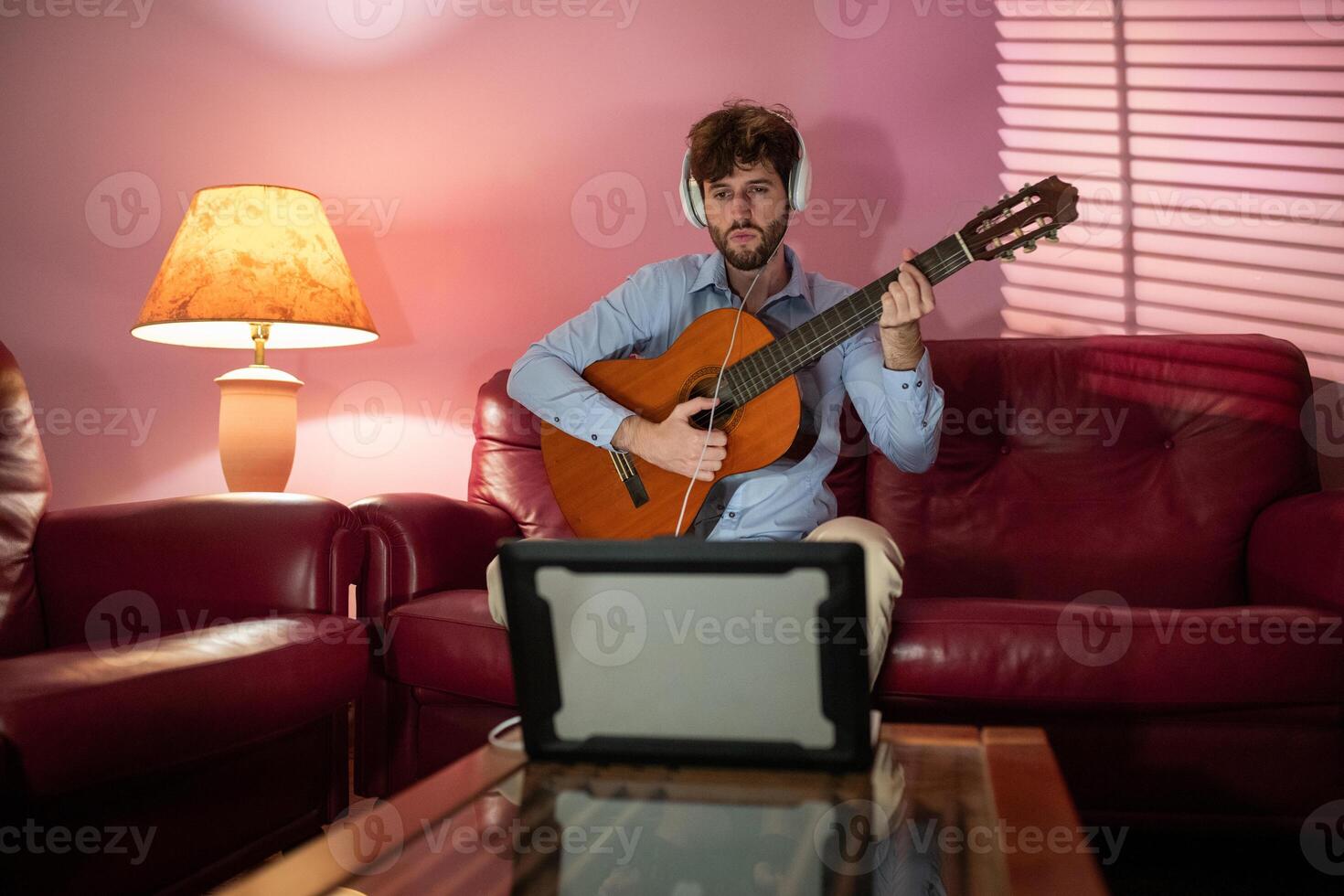 Man Teaching Remote Music Guitar Lesson By Computer Streaming Call photo