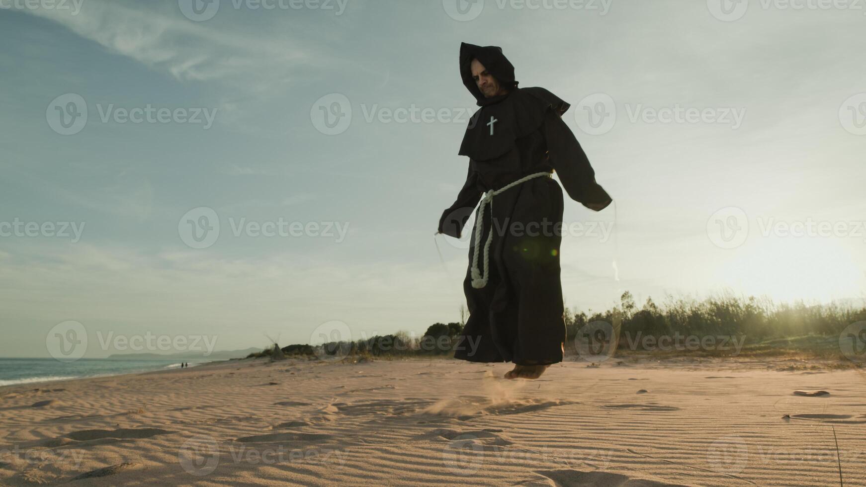 Monk Does Jump Rope Sport Training On The Sand Dunes photo