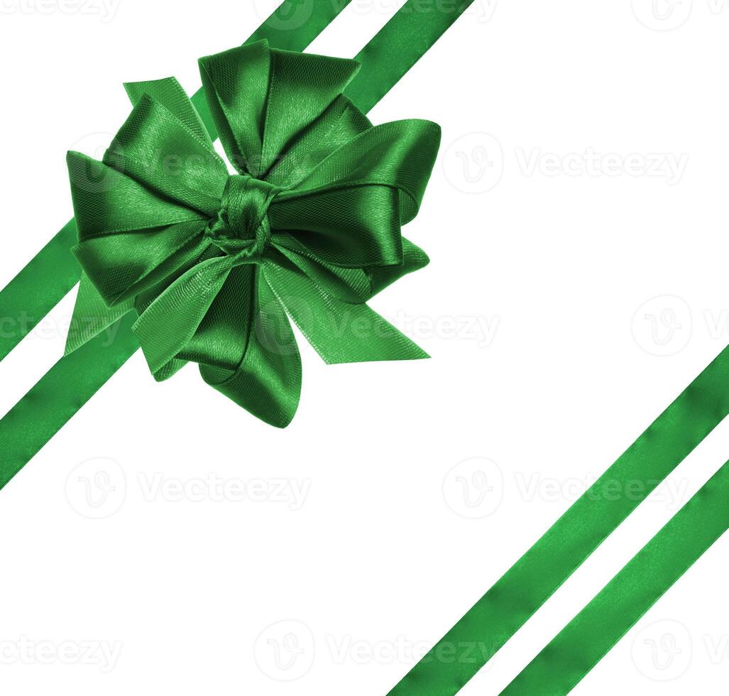 Tied bow made of green silk ribbon on an isolated background, decor for a gift. photo