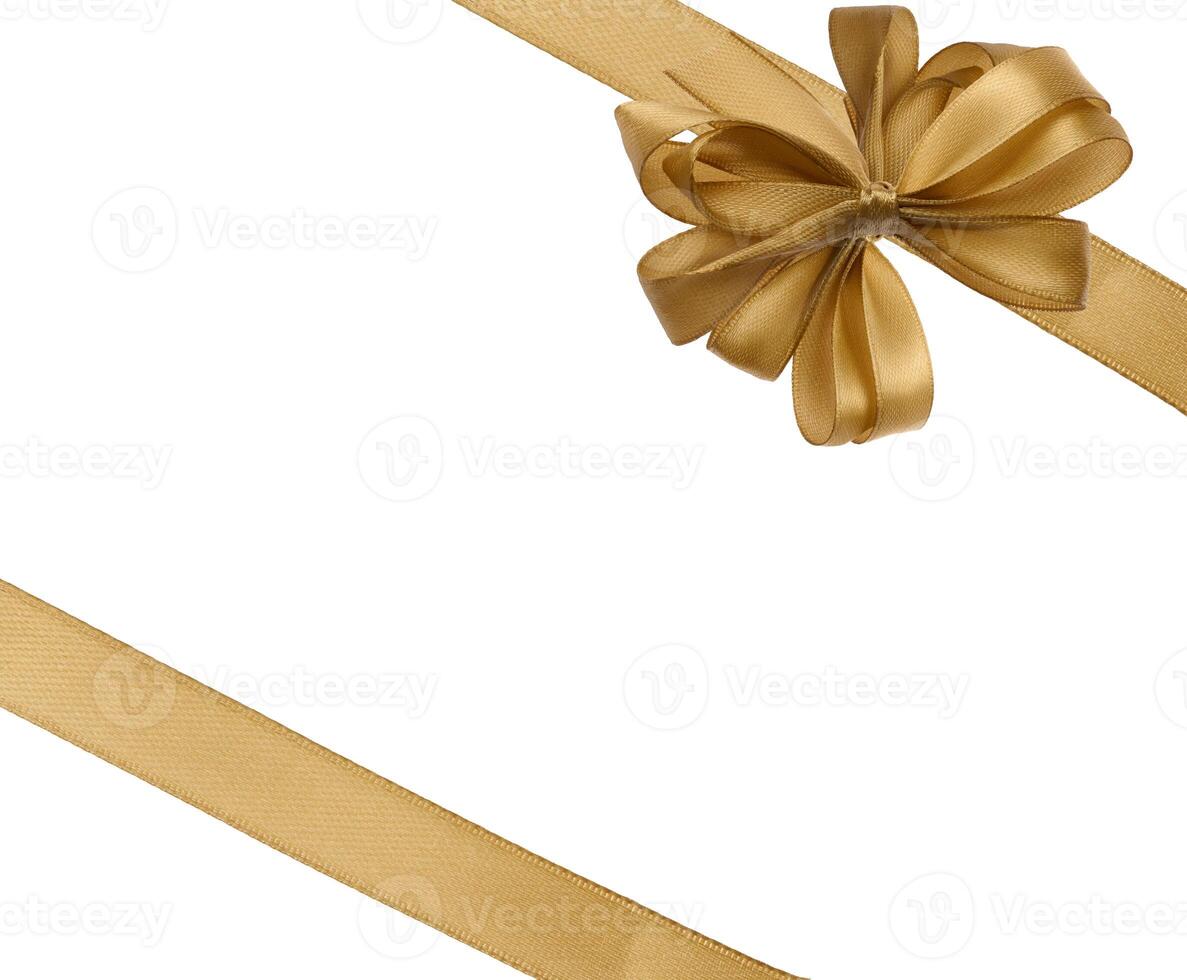 Tied bow made of golden silk ribbon on an isolated background, decor for a gift photo