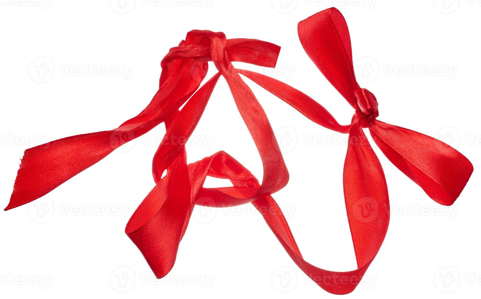 Piece of red satin ribbon on isolated background, top view photo