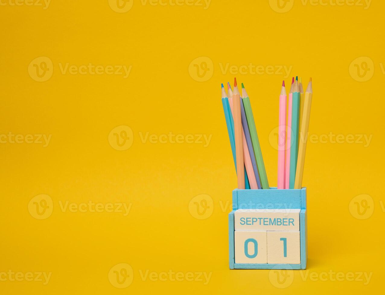 Multi-colored pencils and the date the first of September on the calendar. photo