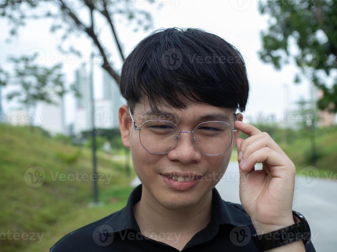 Businessman male man gentleman boy student purpil person people human wear glasses look at camera happy smile copy space manager young adult occupation corporate device outdoor portrait internet work photo