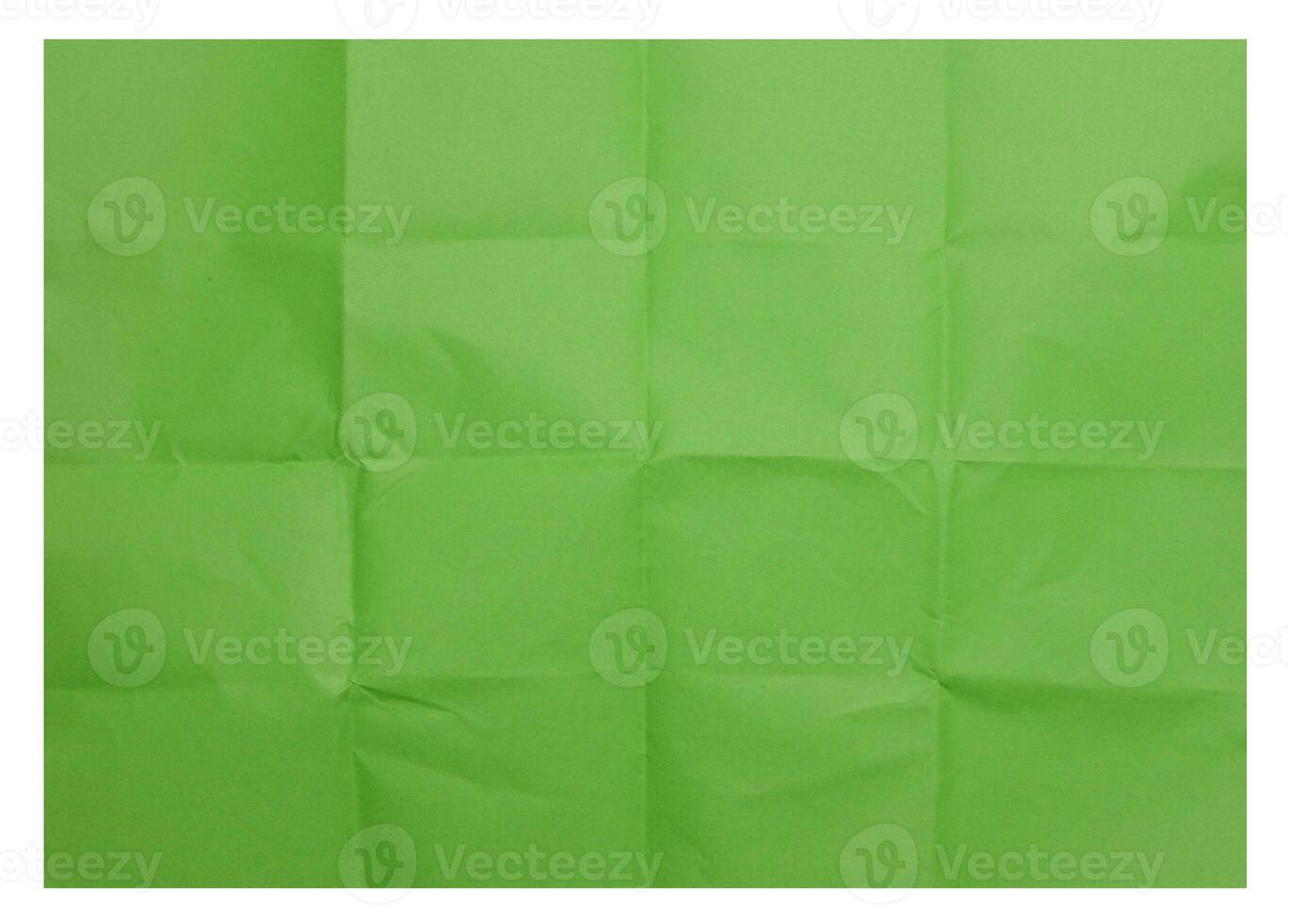 Green folded sheet of paper on isolated background photo