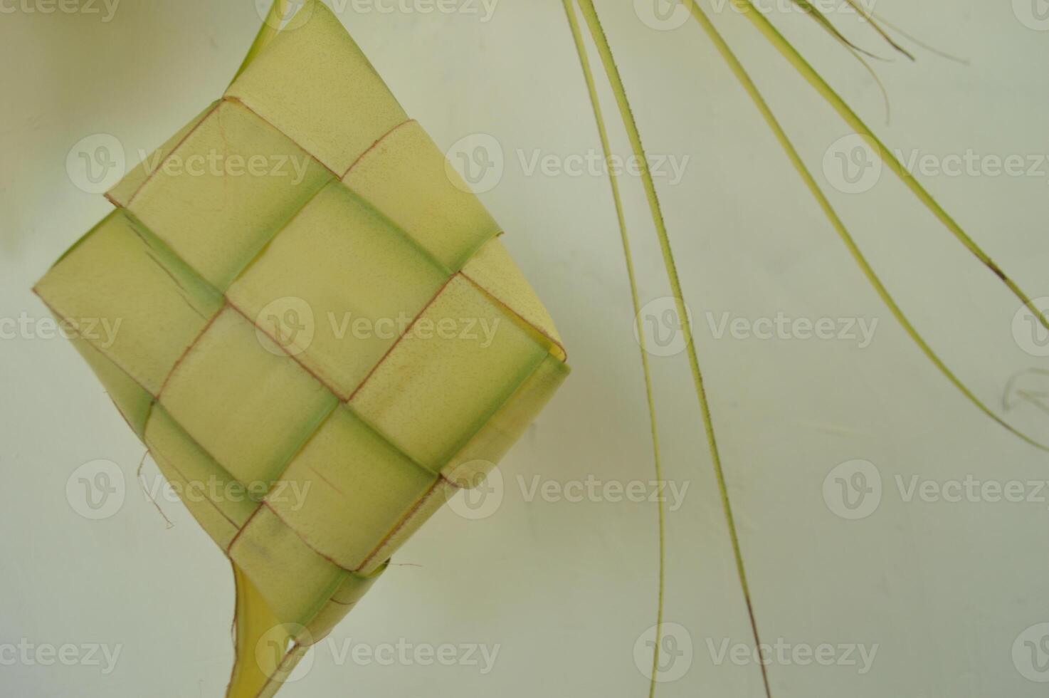Ketupat isolated on white background. A typical Eid al-Fitr dish made from rice wrapped in a wrap made from woven young coconut leaves. typical Malay and Indonesian food photo