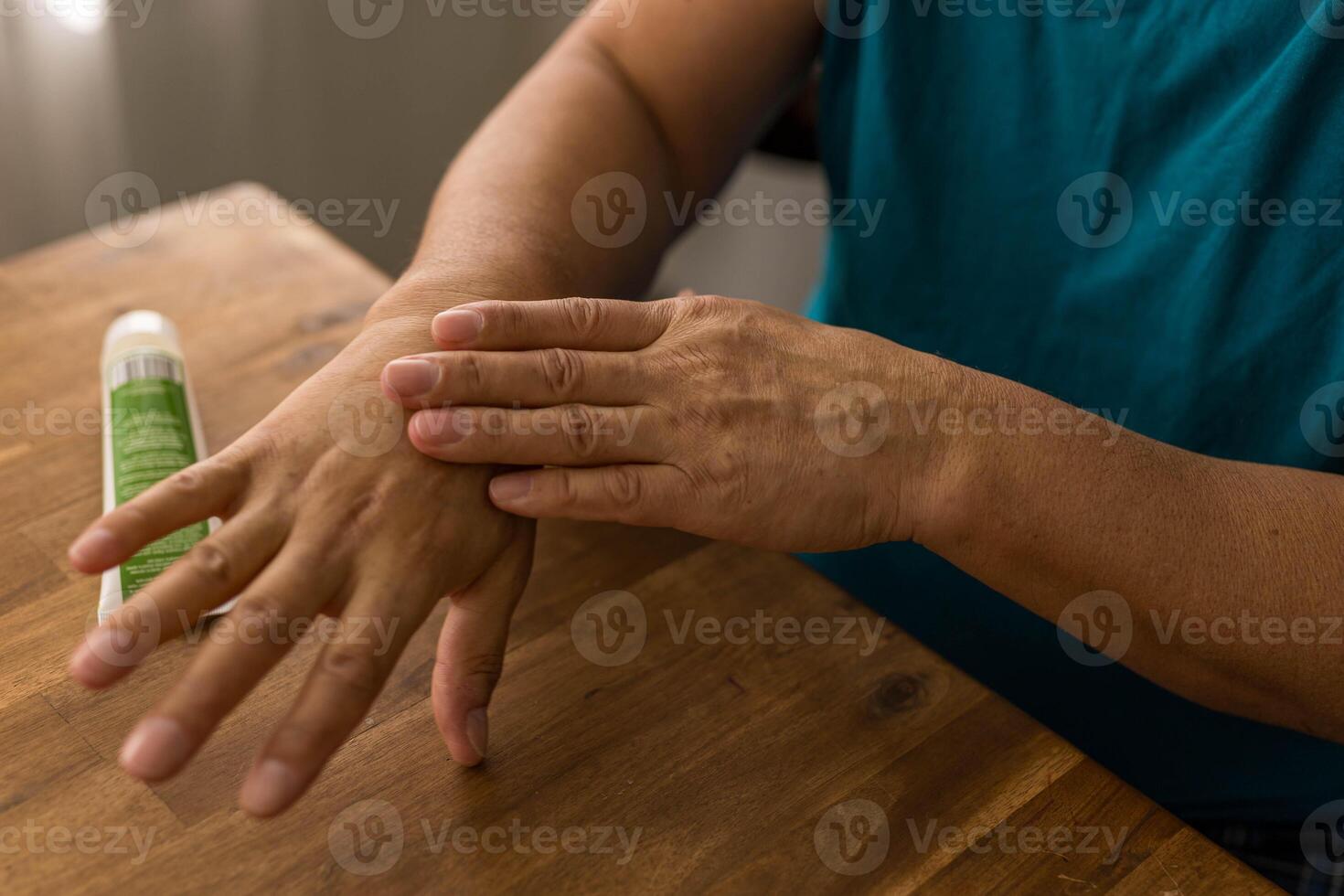 skin care, hands smeared with cream on dark background photo