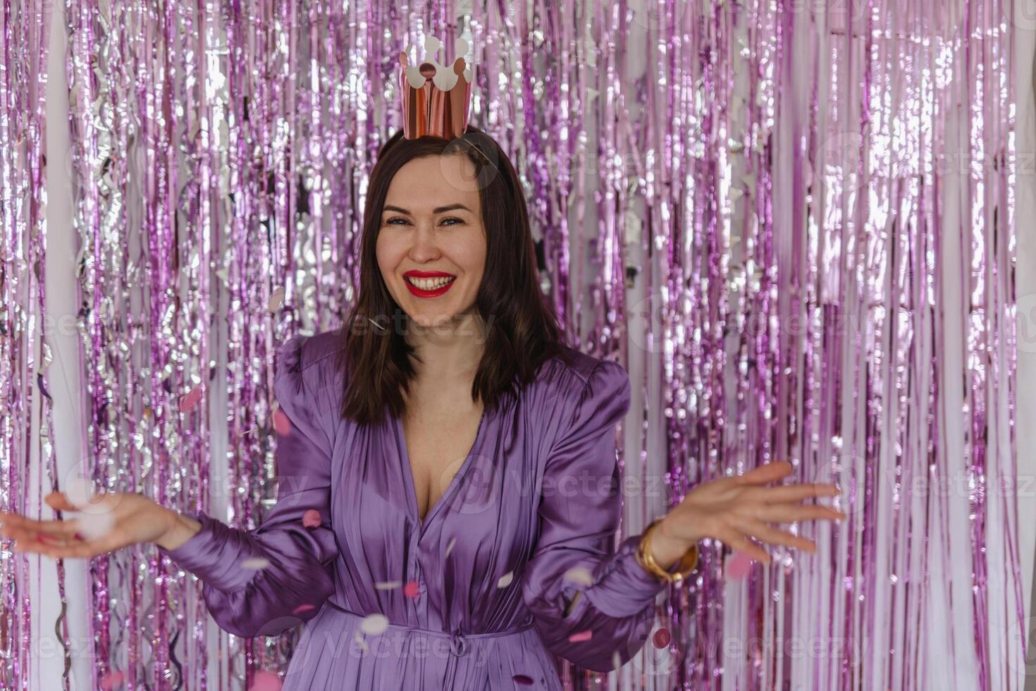 Woman celebrating her 43rd birthday. Bites the cake photo