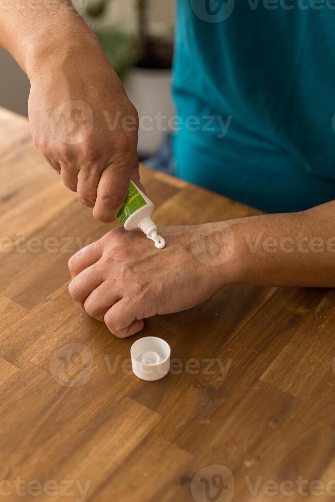 skin care, hands smeared with cream on dark background photo