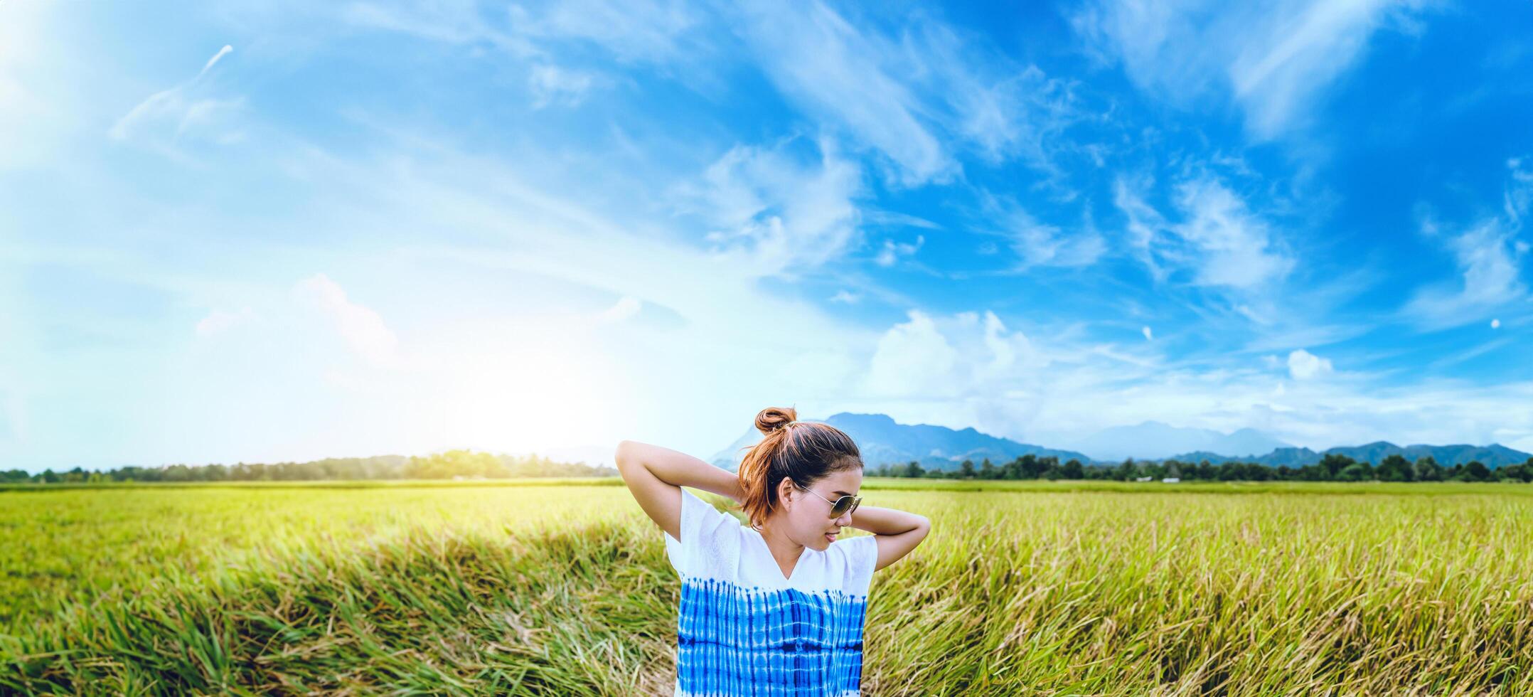 Asian women travel relax in the holiday. Stand natural touch mountain field. Thailand photo