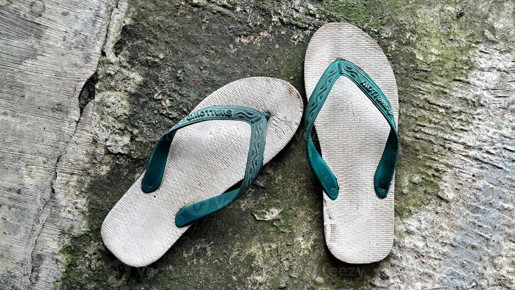 Flip flops hipster concept on plaster background, sendals indonesia Surabaya photo
