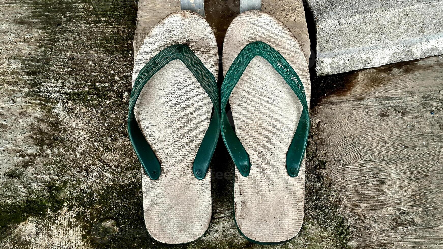 Flip flops hipster concept on plaster background, sendals indonesia Surabaya photo