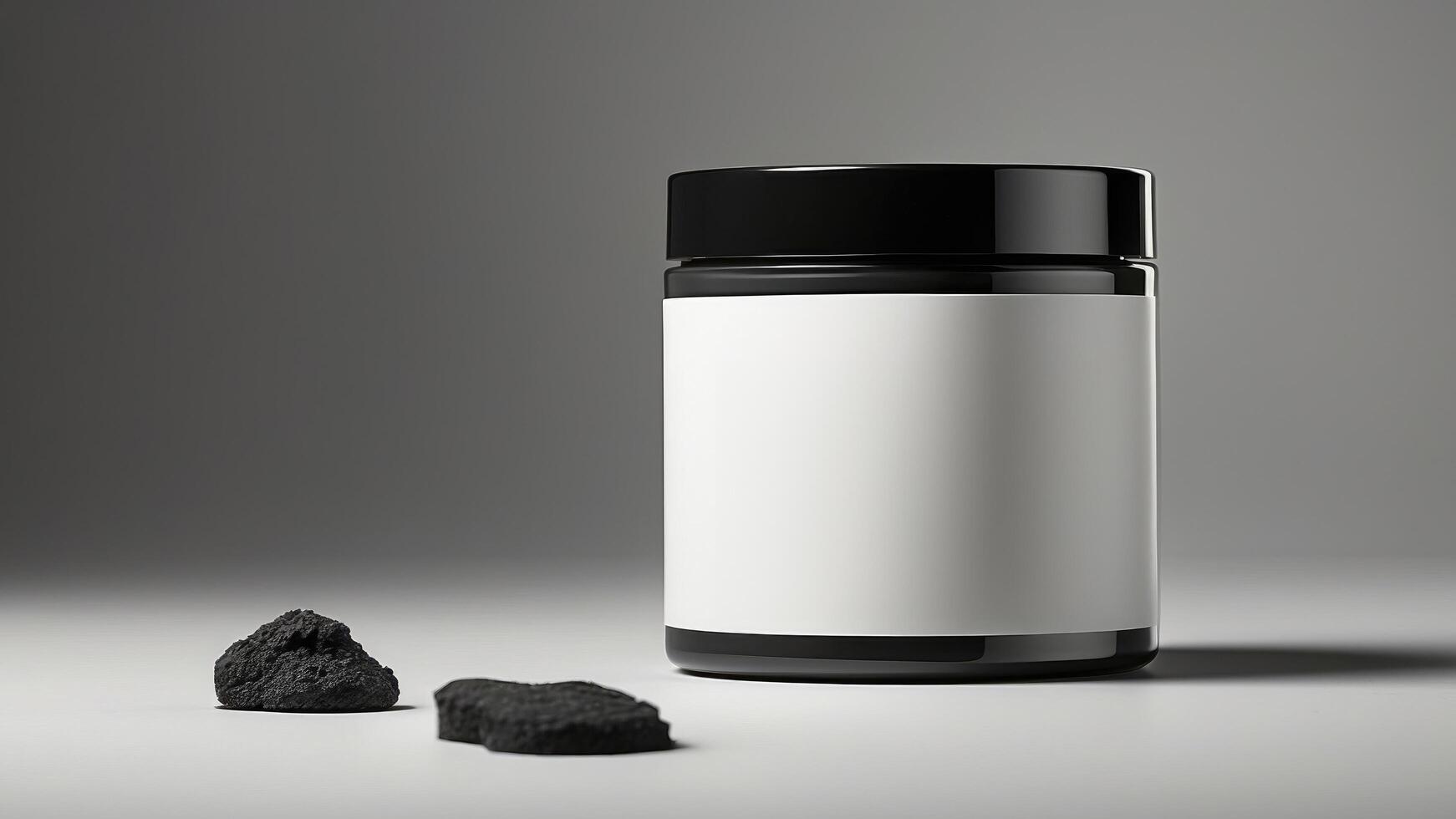 a jar of charcoal next to a black rock photo