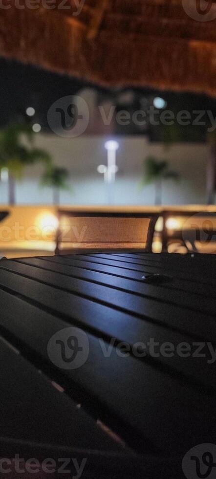 image of dark table in garden with pool at night photo
