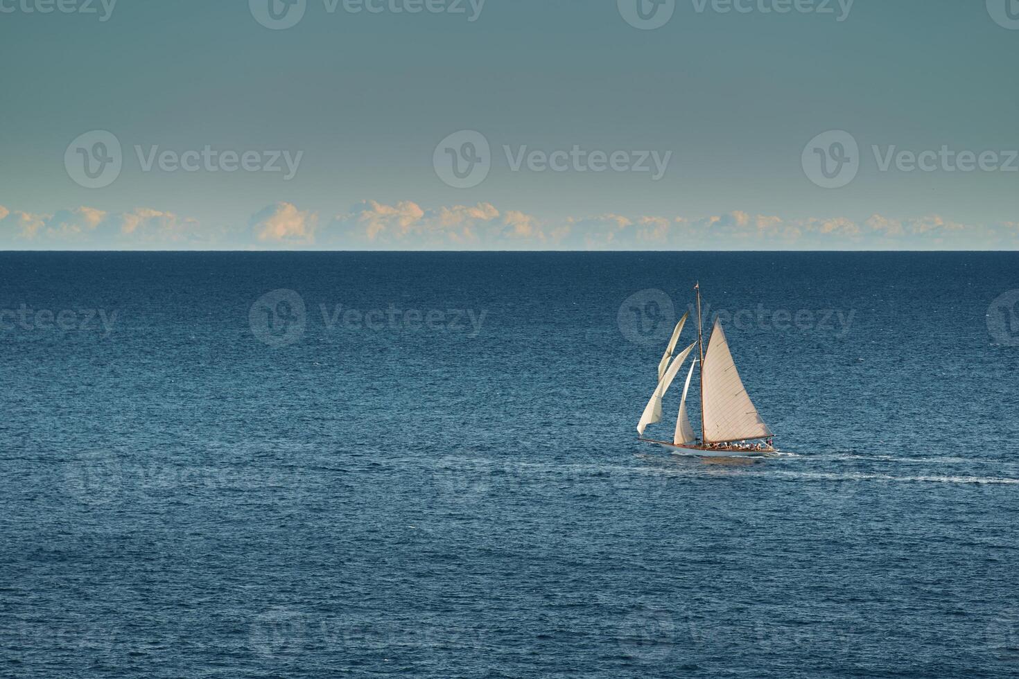 Monaco, lonely vintage sail yacht in sea at sunset, huge sail boat, wealth life of billionaires photo