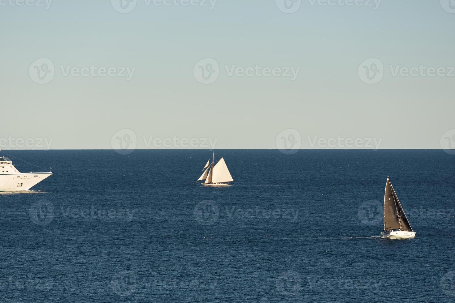 Monaco, vintage sail yacht and huge cruise liner are in sea at sunset, huge motor ship, wealth life of billionaires photo