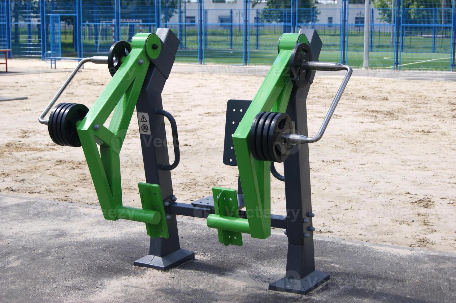 Weight plates on green equipment. photo