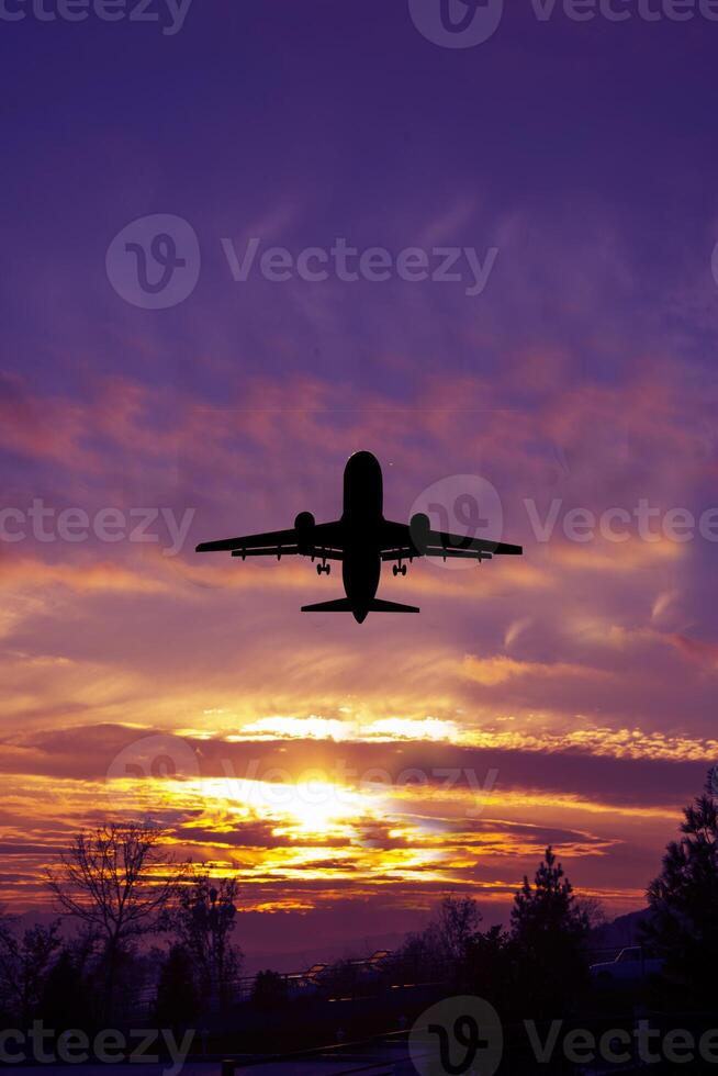 Passengers commercial airplane flying in sunset light. Concept of fast travel, holidays and business photo