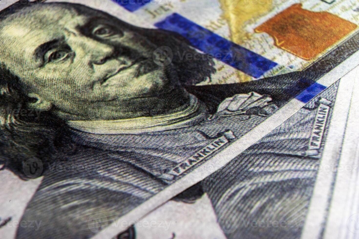 Benjamin Franklin's face on the US 100 dollar bill. Closeup of Ben Franklin on a one hundred dollar bill. Benjamin Franklin portrait from hundred dollar bill macro photo