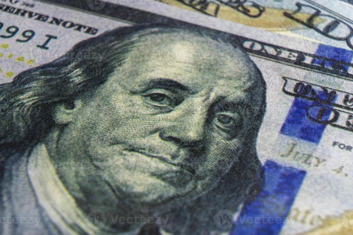 Benjamin Franklin's face on the US 100 dollar bill. Closeup of Ben Franklin on a one hundred dollar bill. Benjamin Franklin portrait from hundred dollar bill macro photo