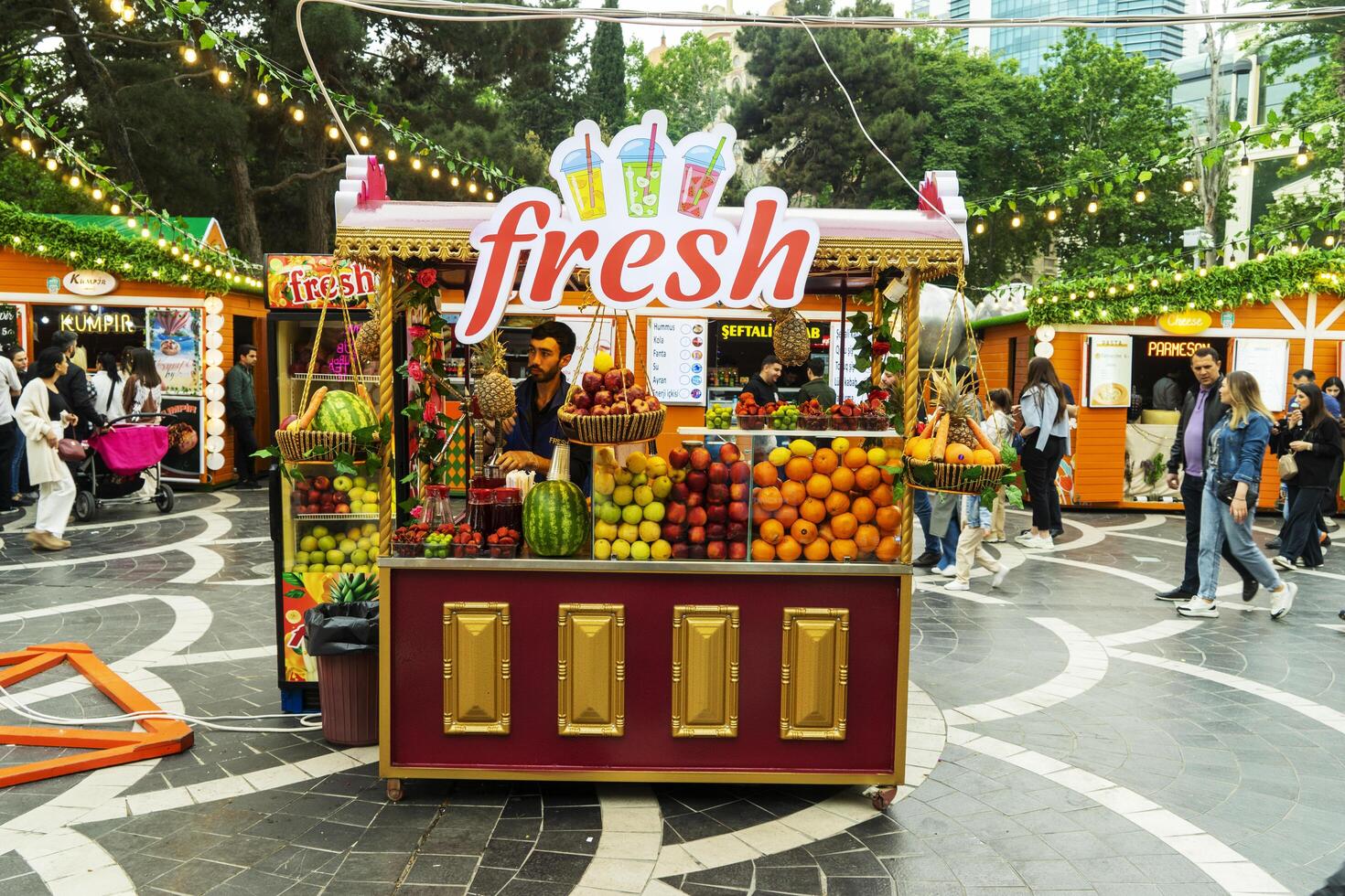 BAKU, AZERBAIJAN - MAY 20, 2020. Fruit and juices at the street farmers market. Fresh summer fruits for juice and smoothies. Summer, vitamins, healthy food concept. photo