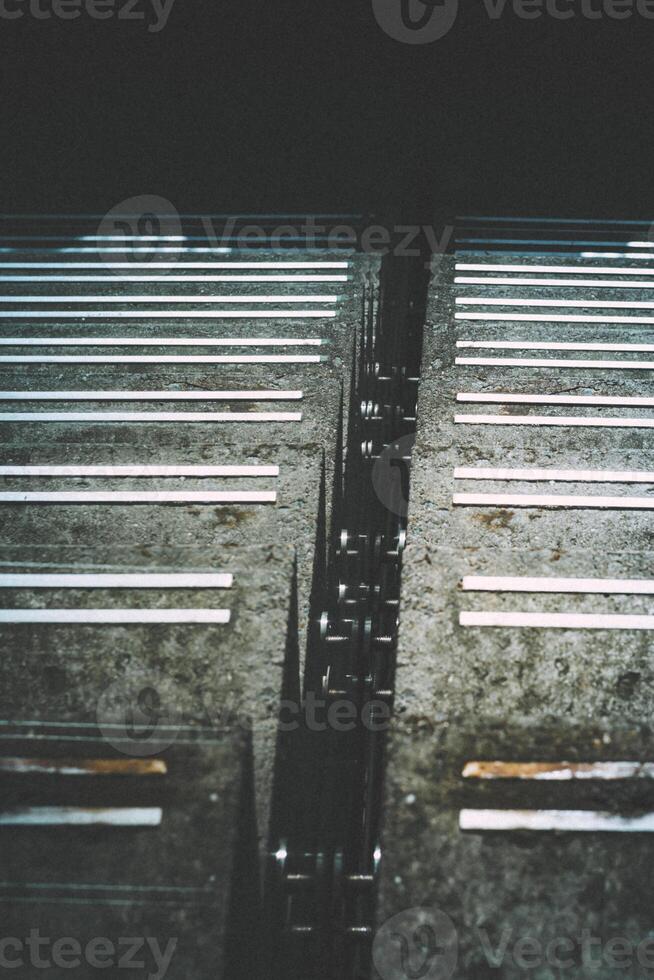 Vertical shot of concrete stairway into the dark deep. Moody and industrial atmosphere photo