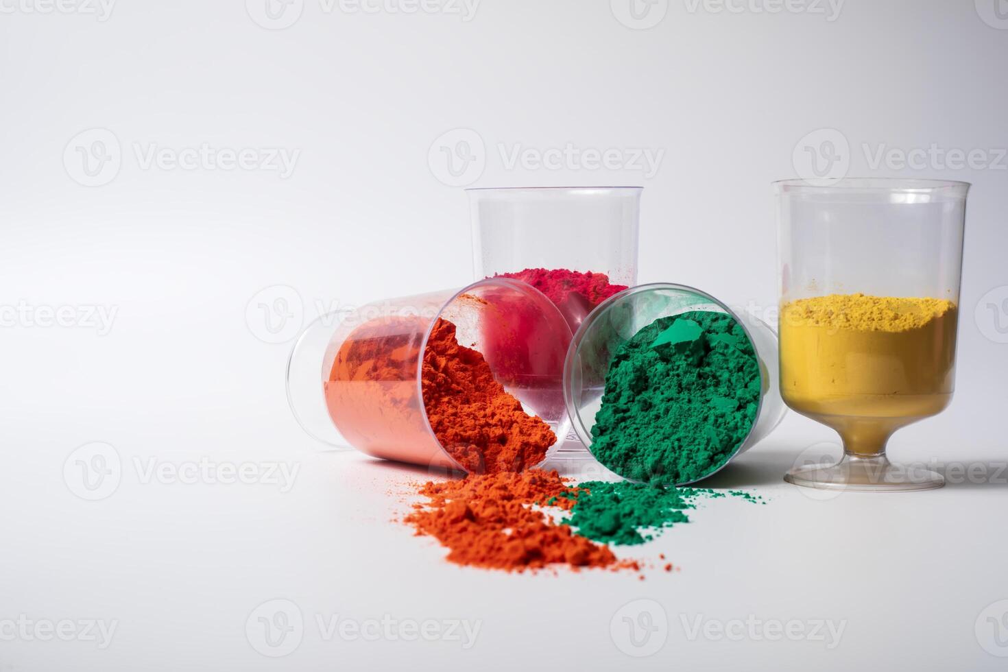 Colorful holi powder in a glass container isolated on white background with copy space. photo